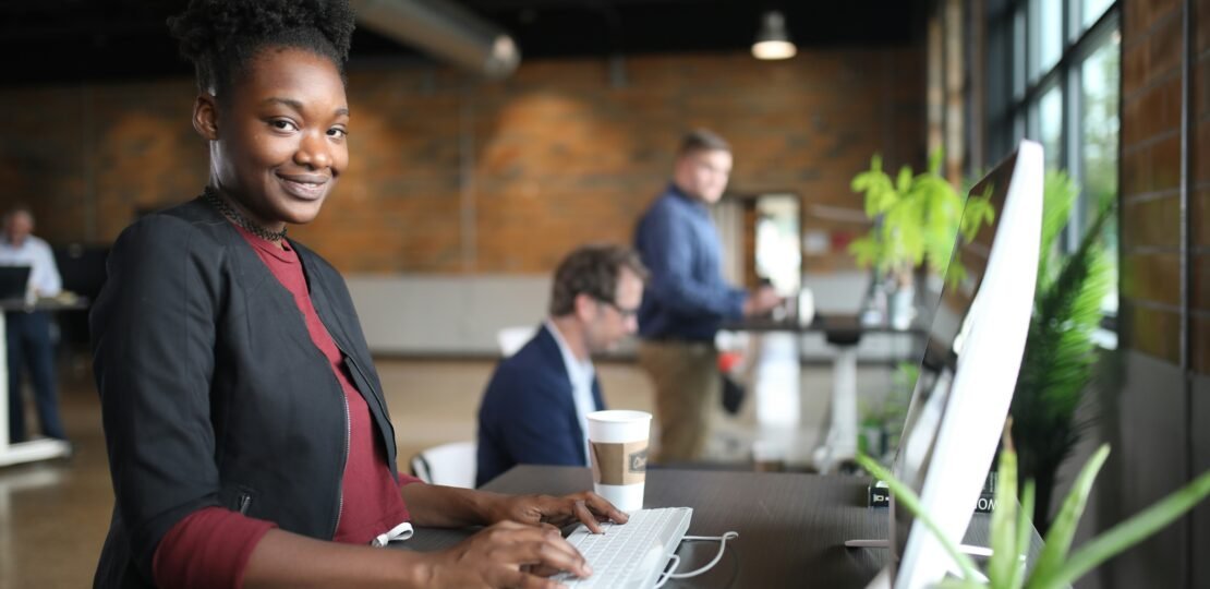 Front desk staff showing a digital tablet to a customer for a soft upsell